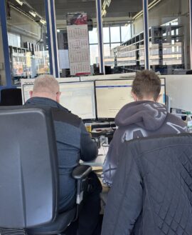 Schüler und Mitarbeiter arbeiten gemeinsam am Computerarbeitsplatz